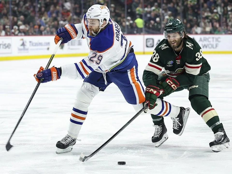  Minnesota Wild right-winger Ryan Hartman, right, steals the puck from Edmonton Oilers centre Leon Draisaitl during the first period of an NHL hockey game on Jan. 15, 2025, in St. Paul, Minn.