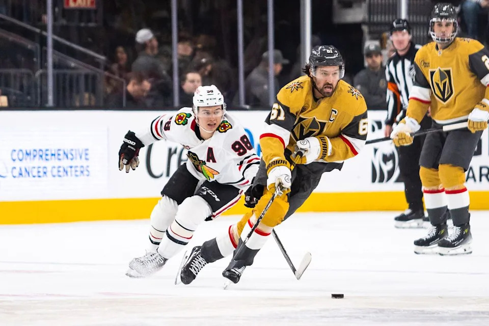 Vegas Golden Knights right-wing Mark Stone (61) skates with the puck as Chicago Blackhawks center Connor Bedard (98) trails behind him during a NHL game between the Vegas Golden Knights and the Chicago Blackhawks, Tuesday December 2, 2025 in Las Vegas, Nev.