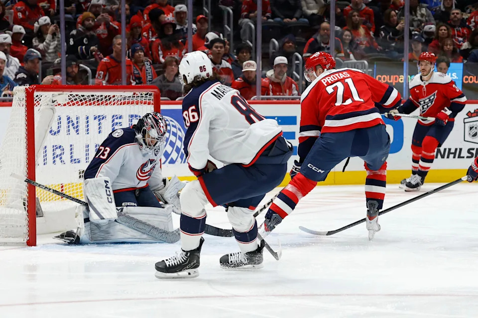 Dec 7, 2025; Washington, District of Columbia, USA; Columbus Blue Jackets goaltender Jet Greaves (73) makes a save on Washington Capitals center Aliaksei Protas (21) during the first period at Capital One Arena. Mandatory Credit: Geoff Burke-Imagn Images