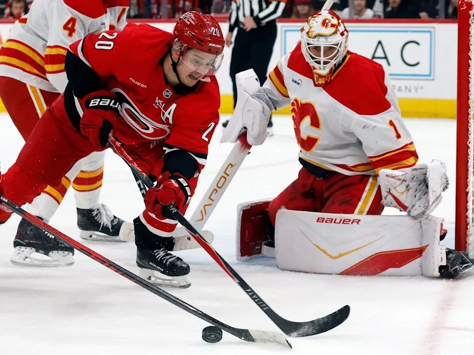  Flames goaltender Devin Cooley keeps tabs on Hurricanes forward Sebastian Aho.