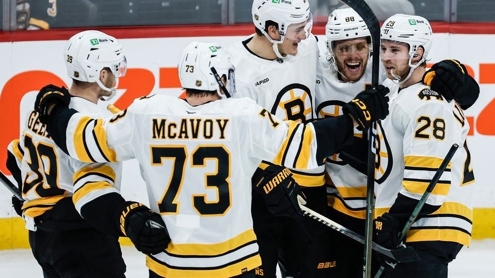 Boston Bruins players celebrate Elias Lindholm's (28) goal against the Winnipeg Jets during the third period of of an NHL hockey game, in Winnipeg, Manitoba, Thursday, Dec. 11, 2025. (John Woods/The Canadian Press via AP)