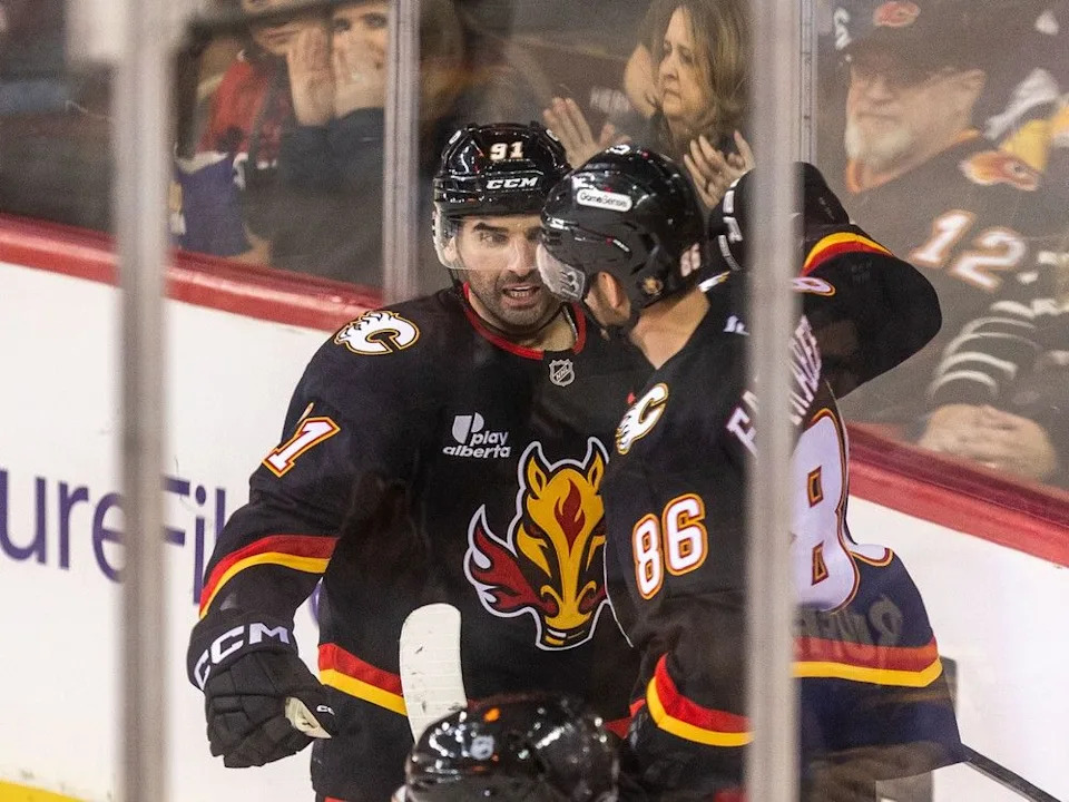 The Calgary Flames celebrate a goal by centre Nazem Kadri in the second period at the Scotiabank Saddledome on Monday, December 8, 2025. Brent Calver/Postmedia