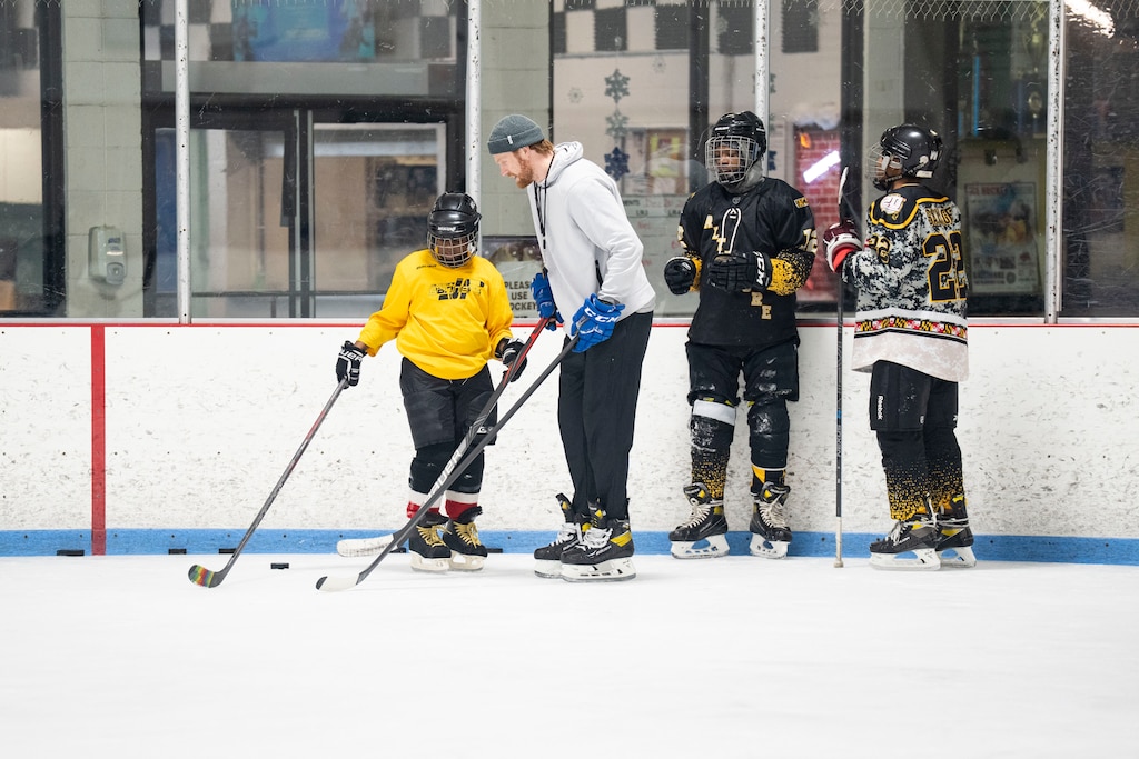 Kaiden Herring gets advice from coach Jack Burton during Baltimore Banner hockey practice at Mt. Pleasant Ice Arena, in Baltimore, Saturday, December 20, 2025.