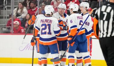 New York Islanders center Bo Horvat (14) celebrates with, from left to right, center Kyle Palmieri, defenseman Ryan Pulock, and defenseman Matthew Schaefer after scoring during the second period of an NHL hockey game against the Detroit Red Wings, Thursday, Nov. 20, 2025, in Detroit. (AP Photo/Ryan Sun)