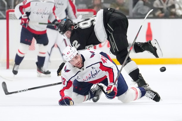 Washington Capitals right wing Tom Wilson, below, and Kings defenseman...