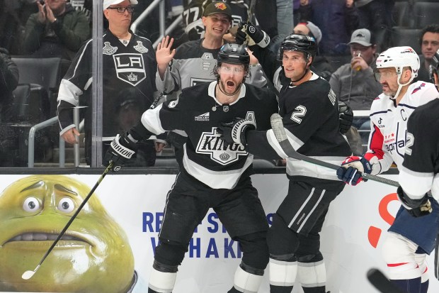 Kings right wing Adrian Kempe, left, celebrates his goal with...