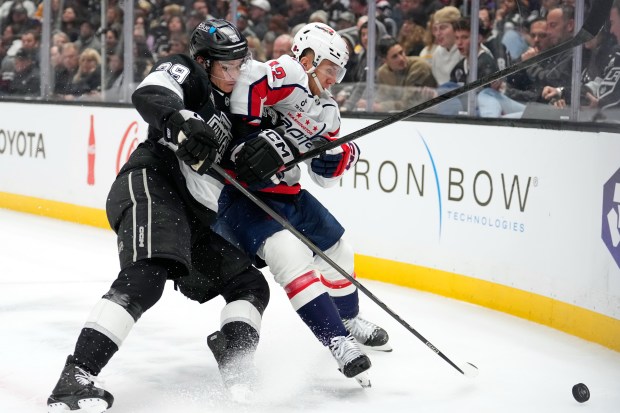 Kings left wing Jeff Malott, left, and Washington Capitals defenseman...