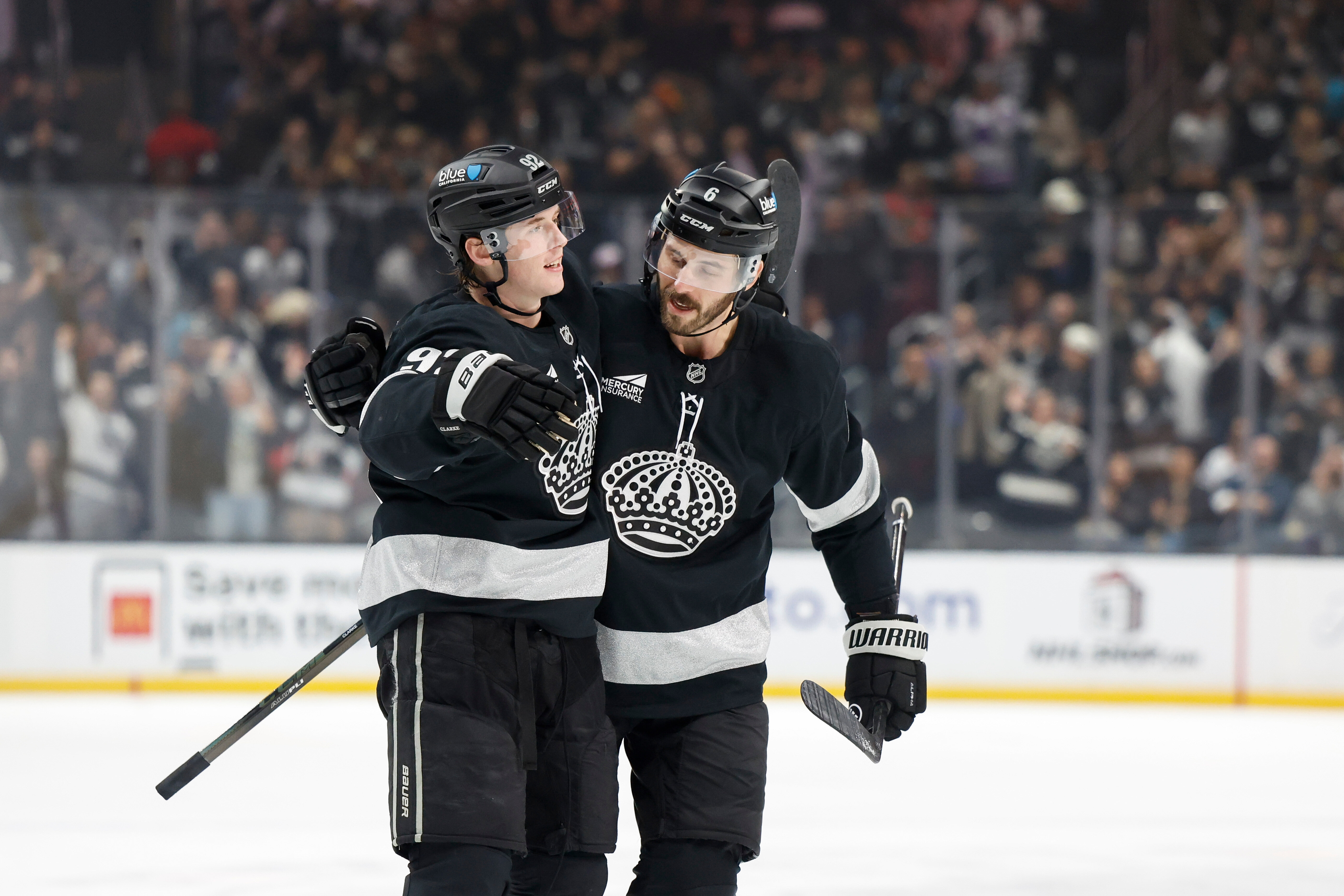 Kings defenseman Brandt Clarke (92) is greeted by defenseman Joel...