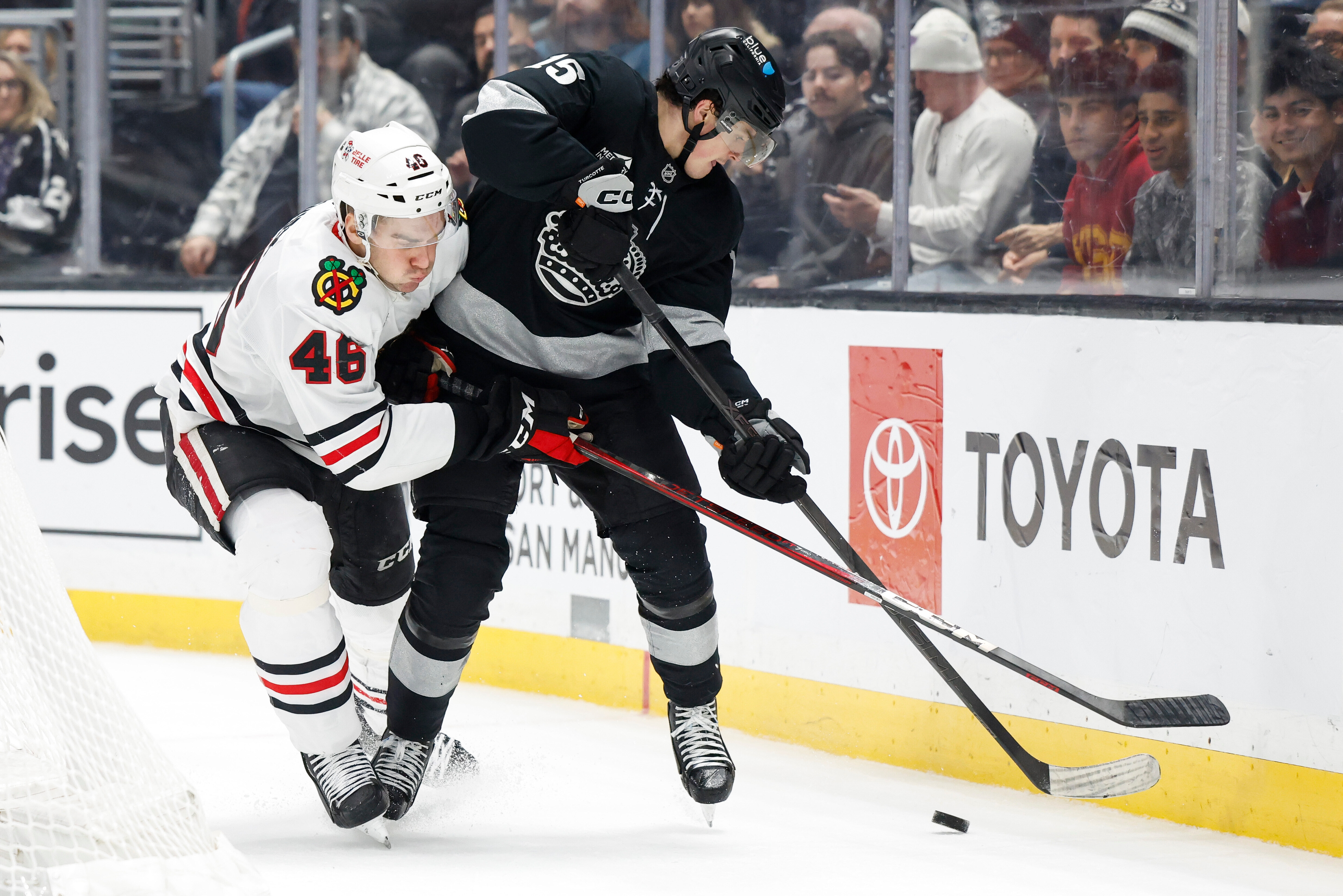 Chicago Blackhawks defenseman Louis Crevier (46) defends Kings center Alex...