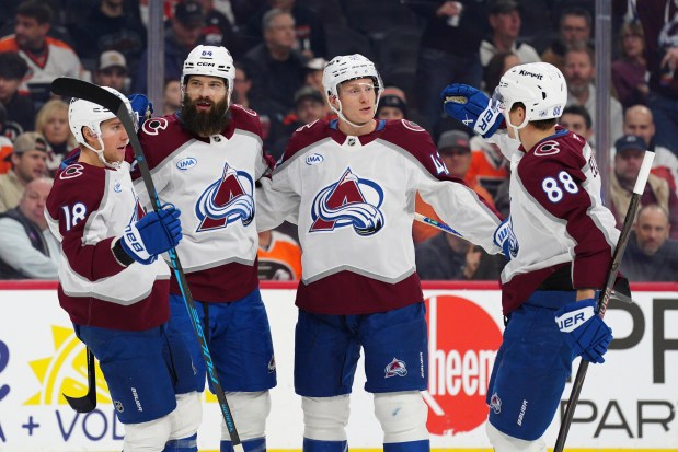 Colorado Avalanche's Brent Burns, second from left, celebrates after his goal with Jack Drury (18), Josh Manson (42) and Martin Necas (88) during the first period of an NHL hockey game against the Philadelphia Flyers, Sunday, Dec. 7, 2025, in Philadelphia. (AP Photo/Derik Hamilton)