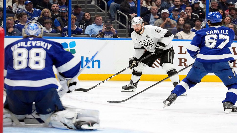 Los Angeles Kings defenseman Drew Doughty (8) looks to shoot between Tampa Bay Lightning goaltender Andrei Vasilevskiy (88) and defenseman Declan Carlile (67) during the third period of an NHL hockey game Thursday, Dec. 18, 2025, in Tampa, Fla. (AP Photo/Chris O'Meara)