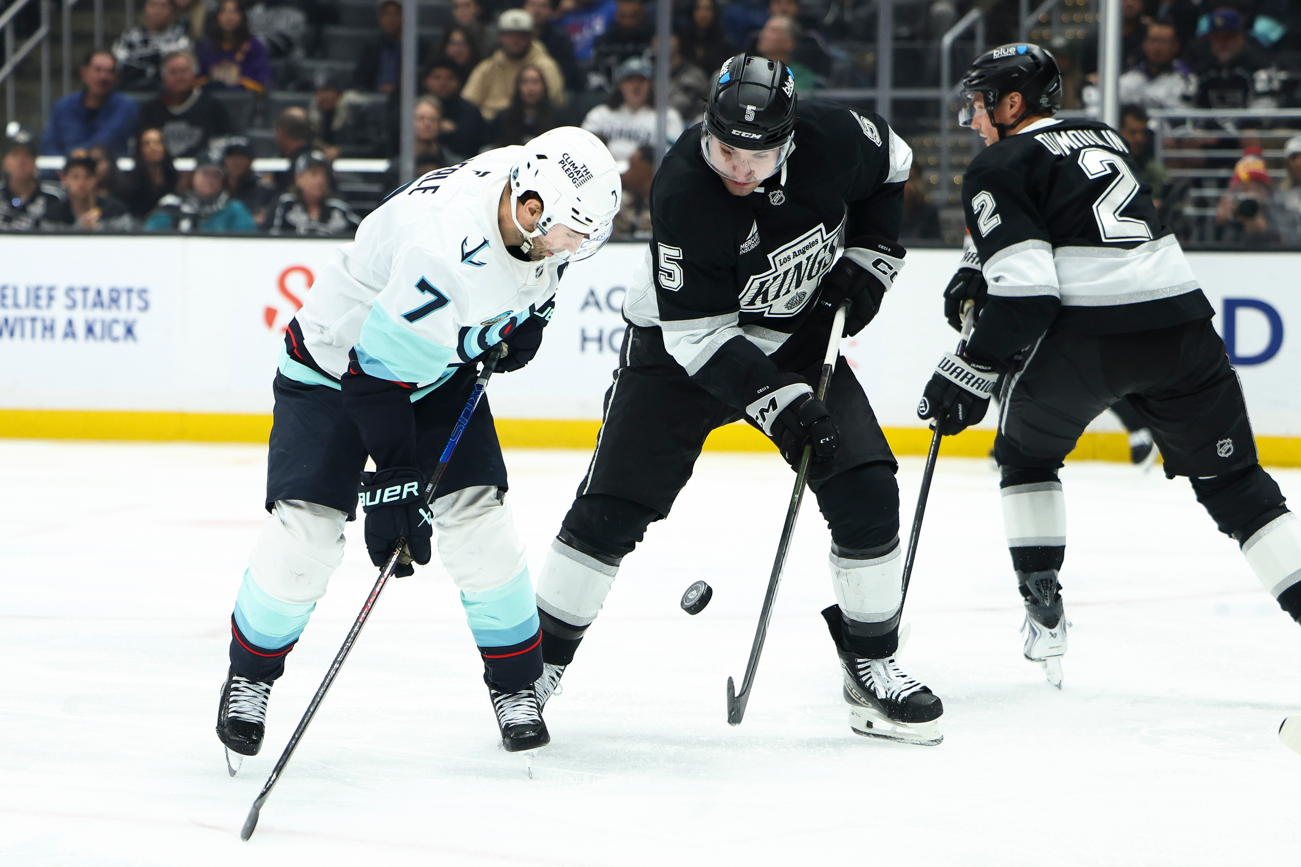 Seattle Kraken right wing Jordan Eberle, left, and Kings defenseman...