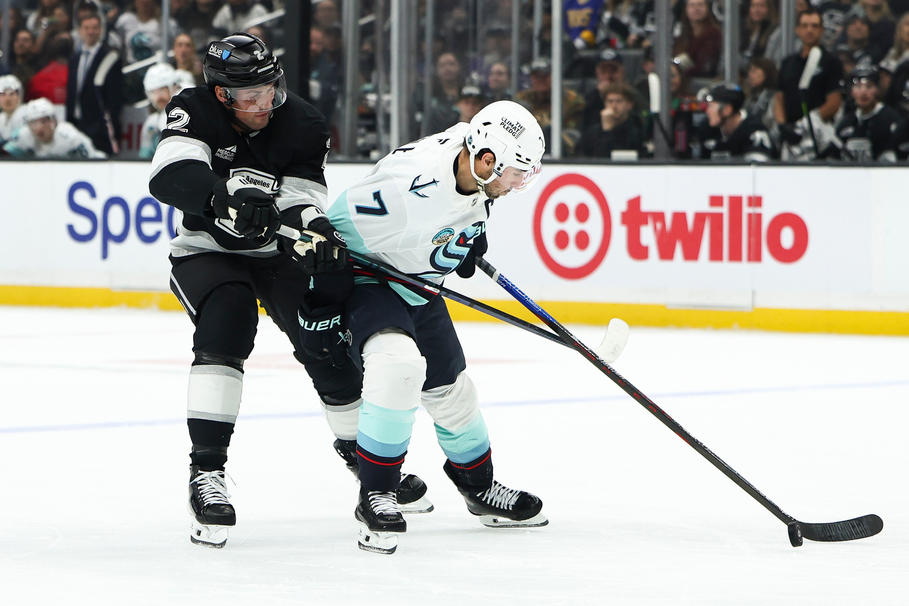 Kings defenseman Brian Dumoulin, left, and Seattle Kraken right wing...