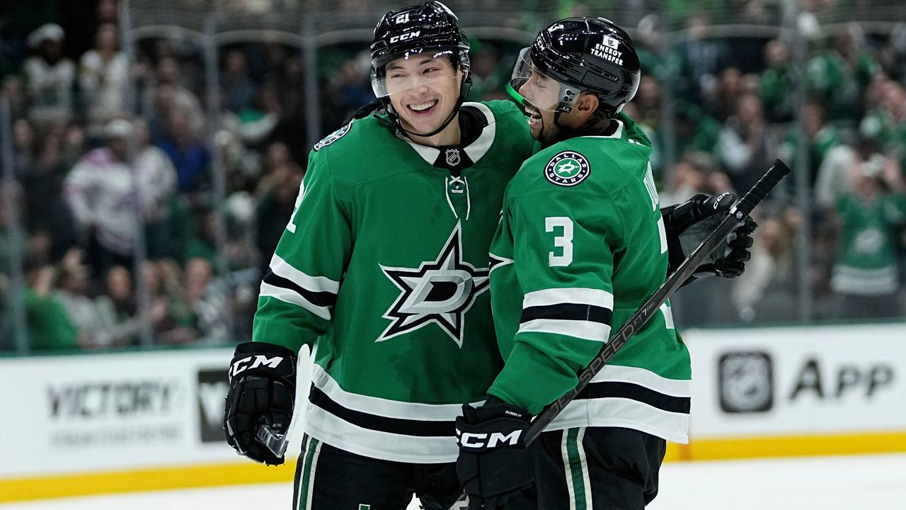 Dallas Stars left wing Jason Robertson (21) and Mathew Dumba (3) celebrate after Robertson scored against the San Jose Sharks in the first period of an NHL hockey game in Dallas, Wednesday, Nov. 20, 2024. (AP Photo/Tony Gutierrez)