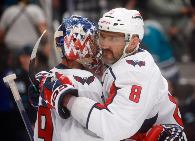 Washington Capitals' Alex Ovechkin (8) hugs Washington Capitals goaltender Charlie Lindgren (79) after their 7-1 win over the San Jose Sharks at the SAP Center in San Jose, Calif., on Wednesday, Dec. 3, 2025. (Nhat V. Meyer/Bay Area News Group)