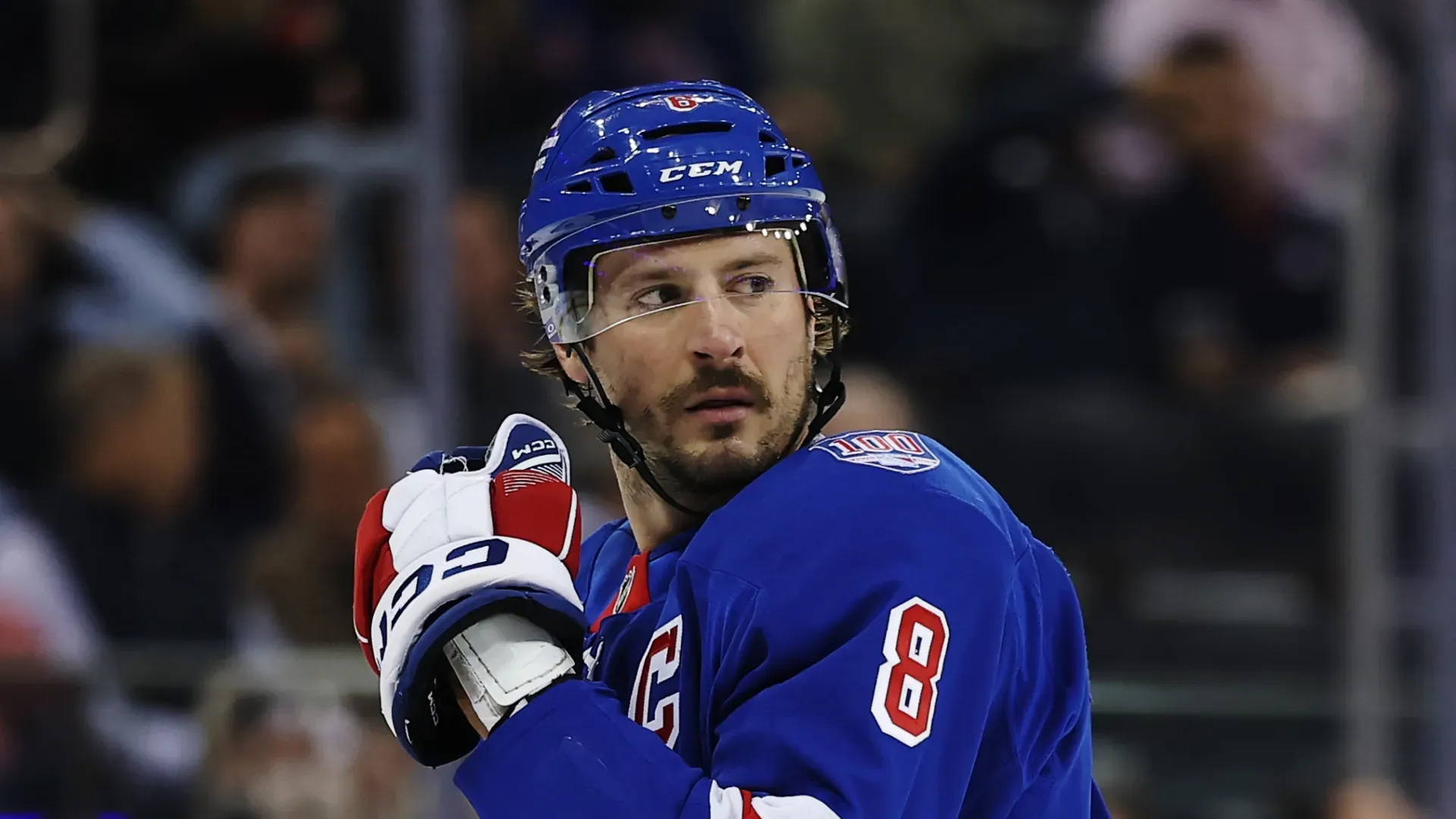 J.T. Miller looks at a teammate