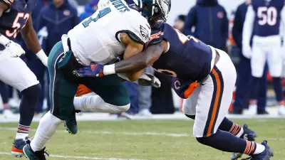 Dec 18, 2022; Chicago, Illinois, USA; Chicago Bears linebacker Joe Thomas (45) tackles Philadelphia Eagles quarterback Jalen Hurts (1) during the second half at Soldier Field.