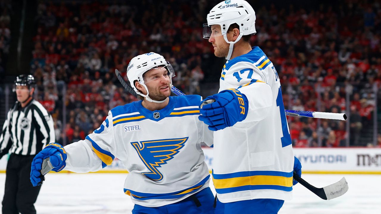 St. Louis Blues Nathan Walker, left, congratulates Cam Fowler (17) after his goal against the New Jersey Devils during the first period of an NHL hockey game, Wednesday, Nov. 26, 2025, in Newark, N.J. (AP Photo/Noah K. Murray)