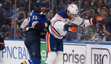St. Louis Blues' Alexey Toropchenko (13) and Edmonton Oilers' Darnell Nurse (25) collide along the boards during the second period of an NHL hockey game Monday, Nov. 3, 2025, in St. Louis. (AP Photo/Jeff Roberson)