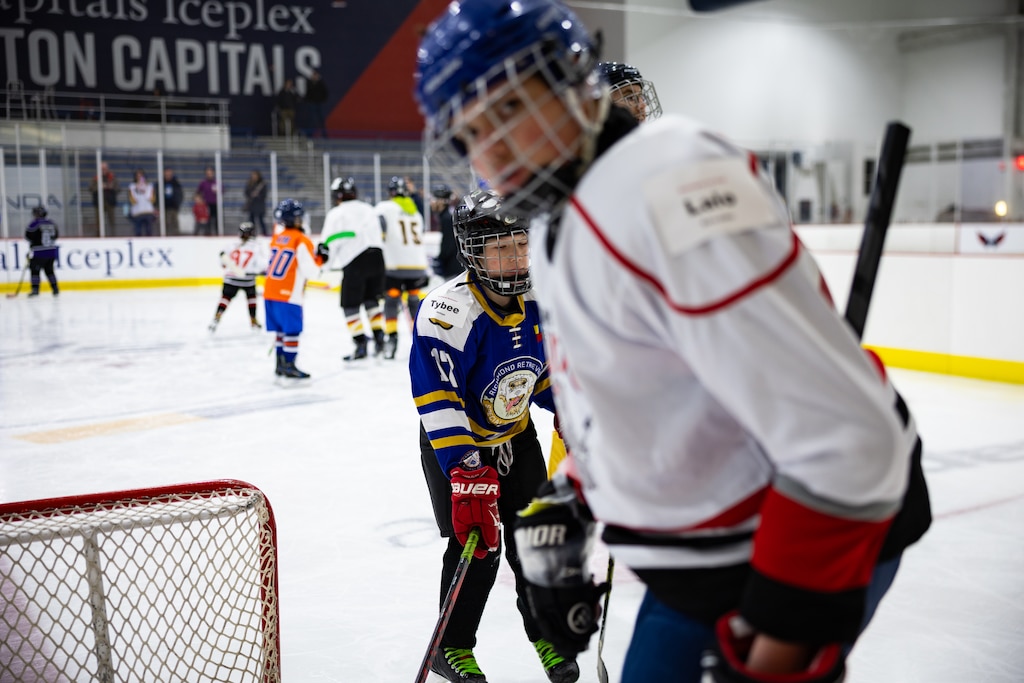 Teams from The American Special Hockey Association, including the Montgomery County Cheetahs (in purple and black), play with Capitals players Alexander Ovechkin, Justin Sourdif, Ethen Frank and veteran Mike Green at the Medstar Iceplex in Arlington, VA on December 10, 2025.