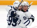 Toronto Maple Leafs Oliver Ekman-Larsson, left, celebrates with Easton Cowan after scoring during the first period against the Penguins in Pittsburgh, Saturday, Nov. 29, 2025. 