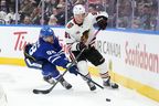 Maple Leafs'William Nylander (left) and Chicago Blackhawks' Frank Nazar vie for control of the puck during the third period in Toronto, Tuesday, Dec. 16, 2025. 