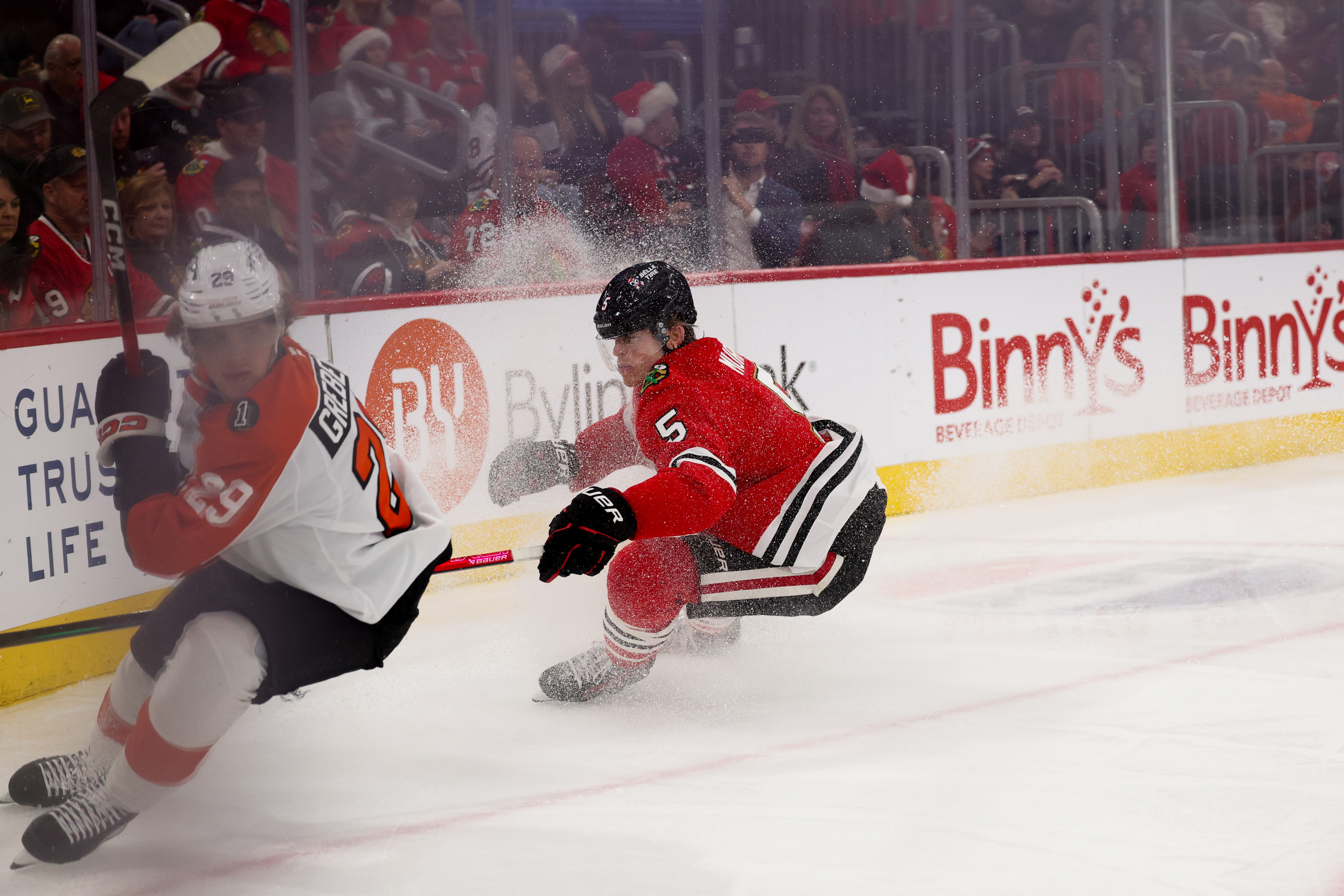 Philadelphia Flyers right wing Nikita Grebenkin (29) and Chicago Blackhawks defenseman Connor Murphy (5) chase after the puck during the second period at the United Center Tuesday Dec. 23, 2025 in Chicago. (Armando L. Sanchez/Chicago Tribune)