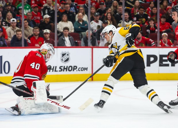 Blackhawks goaltender Arvid Soderblom (40) saves a shot by Pittsburgh Penguins right wing Rickard Rakell (67) during the second period, Dec. 28, 2025, at the United Center. (Dominic Di Palermo/Chicago Tribune)