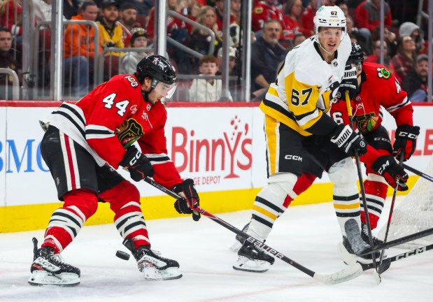 Blackhawks defenseman Wyatt Kaiser (44) tries too grab the puck during the second period against the Pittsburgh Penguins, Dec. 28, 2025, at the United Center. (Dominic Di Palermo/Chicago Tribune)