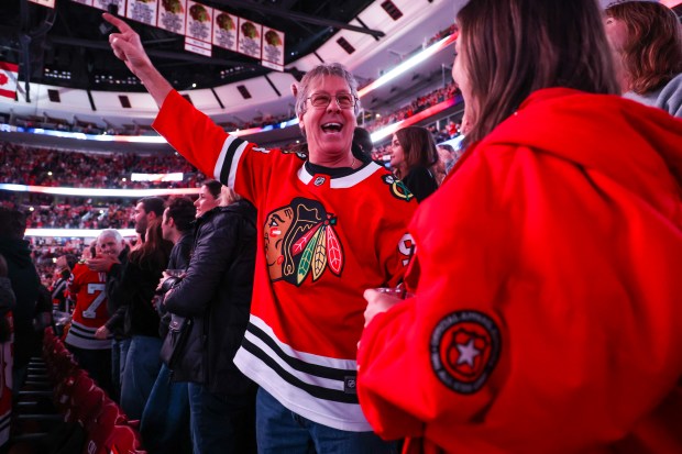 Len Santoro of Mundelein, left, cheers with his daughter Ashley Santoro before a game between the Blackhawks and the Pittsburgh Penguins, Dec. 28, 2025, at the United Center. (Dominic Di Palermo/Chicago Tribune)