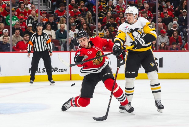 Blackhawks defenseman Louis Crevier (46) swats at the puck during the second period against the Pittsburgh Penguins, Dec. 28, 2025, at the United Center. (Dominic Di Palermo/Chicago Tribune)