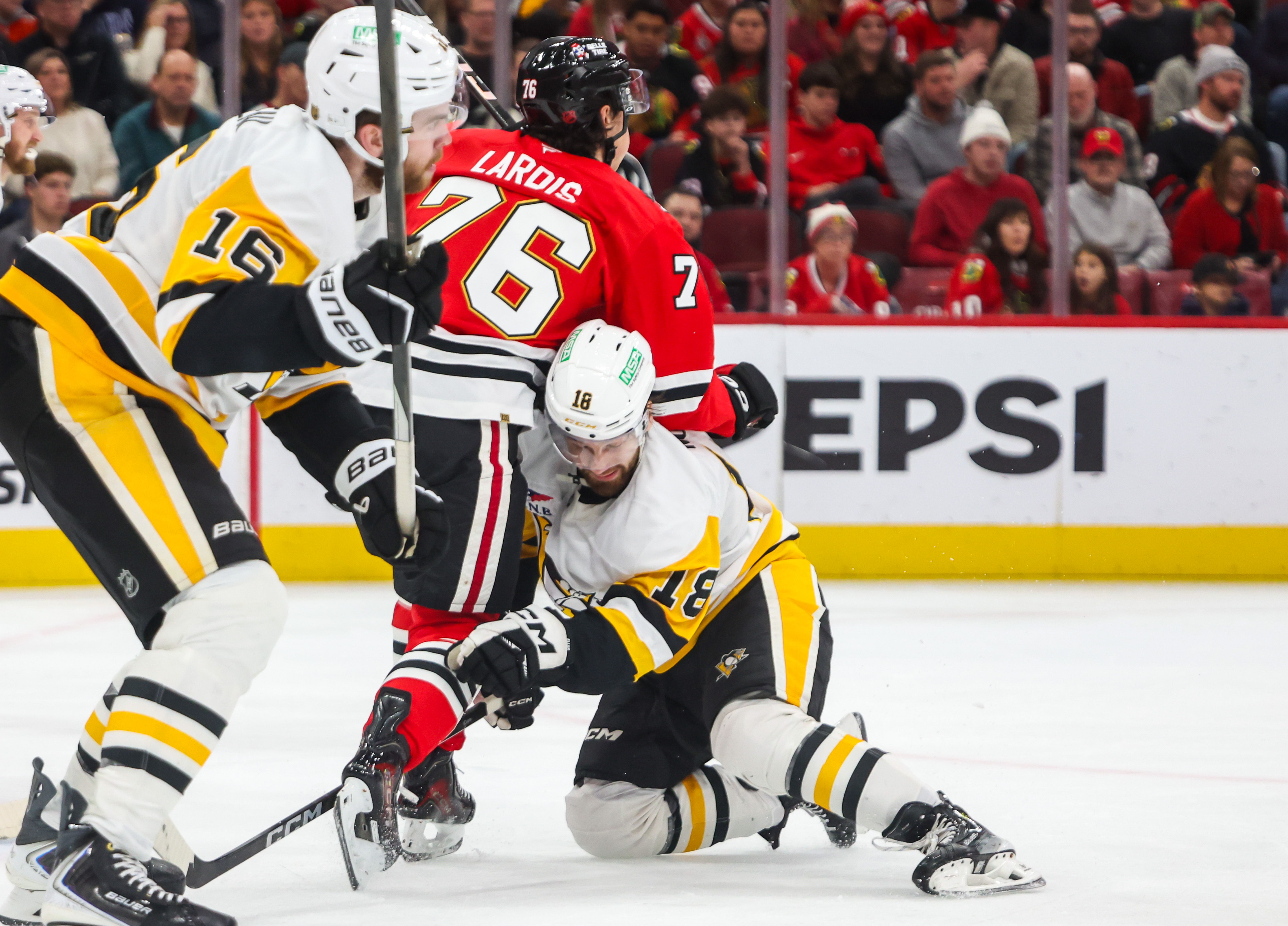 Blackhawks left wing Nick Lardis (76) and Pittsburgh Penguins center Tommy Novak (18) collide during the second period, Dec. 28, 2025, at the United Center. (Dominic Di Palermo/Chicago Tribune)