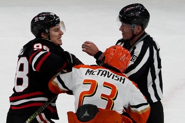 Blackhawks center Connor Bedard and Ducks center Mason McTavish fight during the third period Sunday, Nov. 30, 2025, at the United Center. (AP Photo/David Banks)