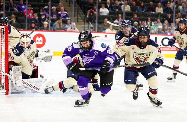 Minnesota Frost Captain, Kendall Coyne Schofield (26), left, and Montreal Victoire, Amanda Boulier (44) chase down a loose puck during a game at the Xcel Energy Center on March 26, 2025, in St. Paul, Minnesota. (Stacey Wescott/Chicago Tribune)