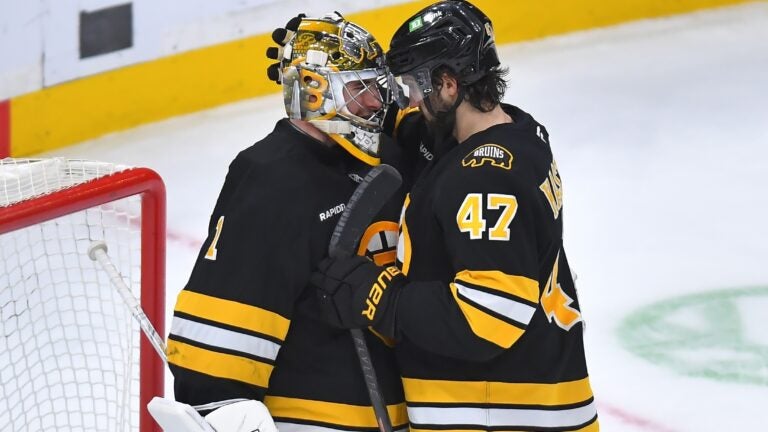 Boston Bruins goaltender Jeremy Swayman (1) celebrates with center Mark Kastelic (47) after the Bruins beat the New Jersey Devils in an NHL hockey game, Saturday, Dec. 6, 2025, in Boston.