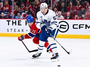 Easton Cowan of the Toronto Maple Leafs handles the puck against Jake Evans of the Montreal Canadiens during the second period at the Bell Centre on Nov. 22, 2025 in Montreal.
