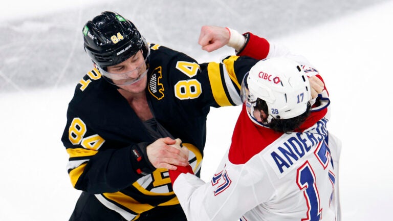 Boston Bruins left wing Tanner Jeannot (84) and Montréal Canadiens right wing Josh Anderson (17) fight right after the puck drop during the first period at TD Garden on Dec. 23, 2025. (