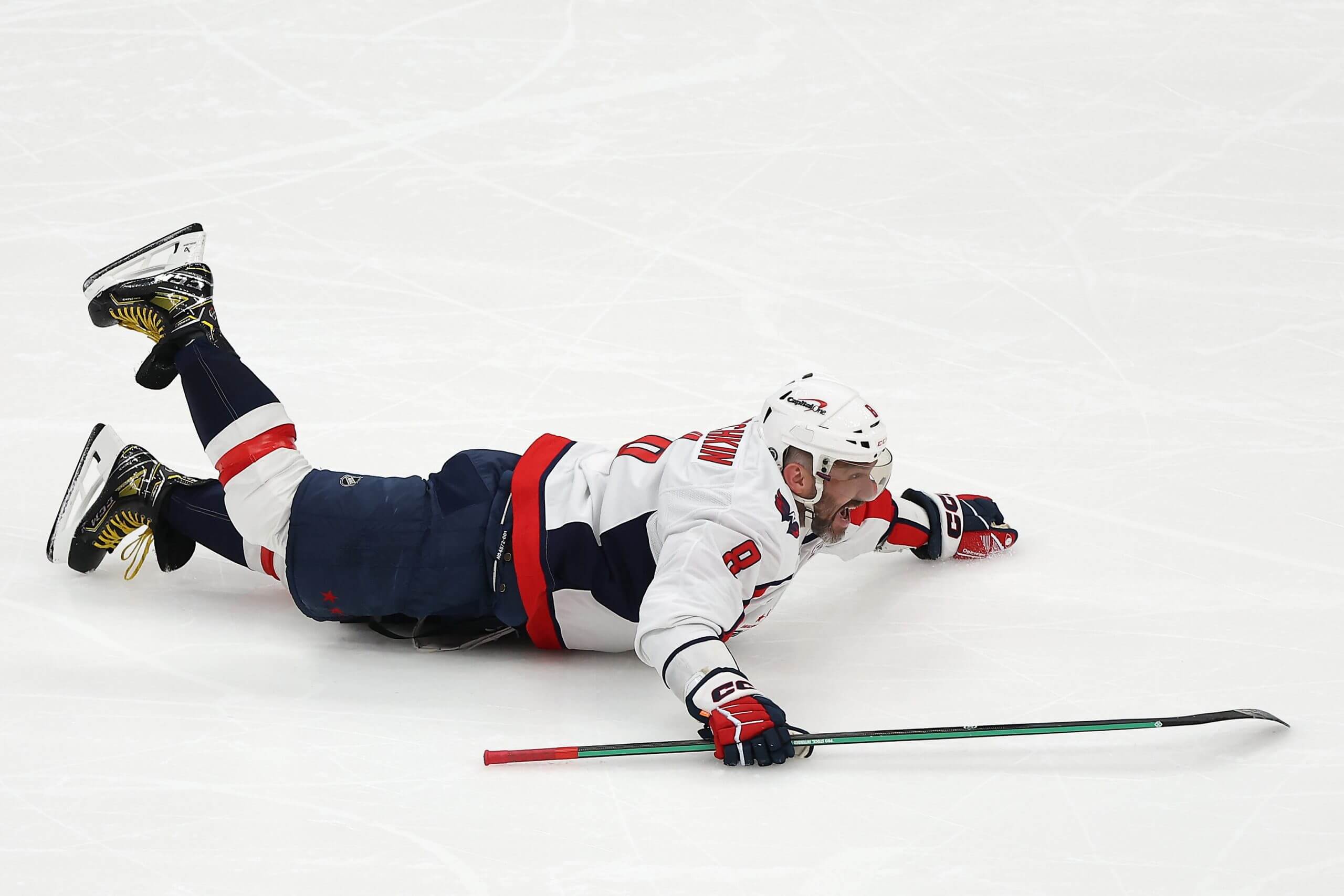 Alex Ovechkin slides on his belly after scoring the record-breaking goal.
