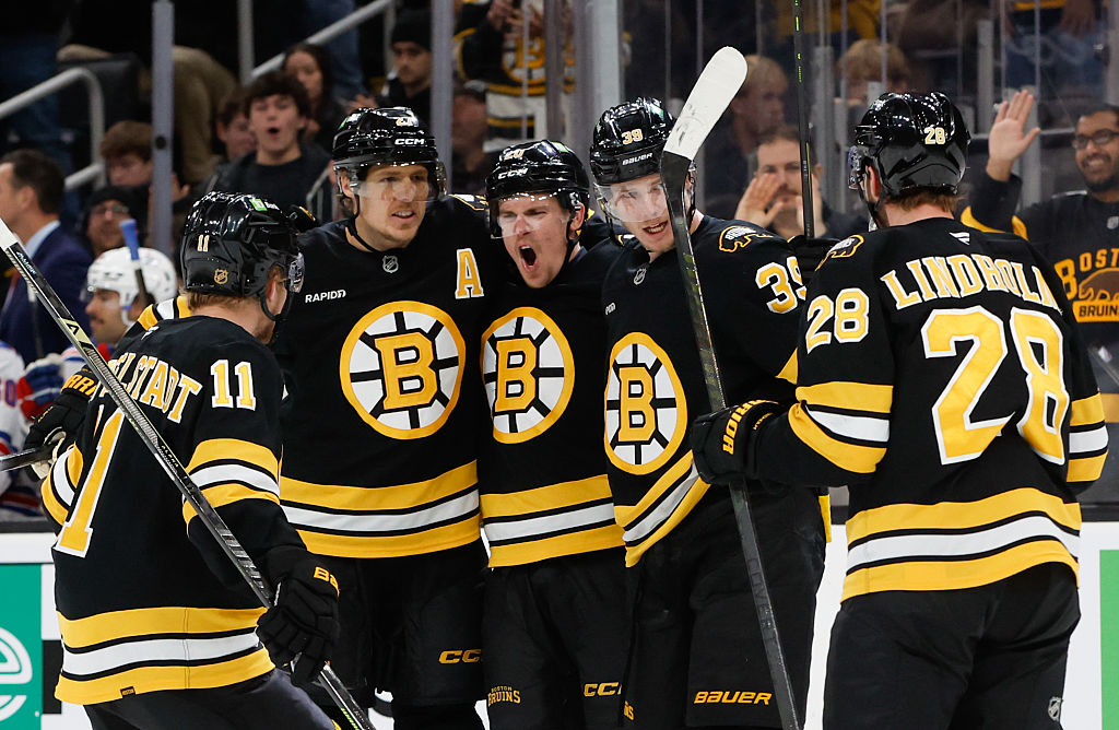 BOSTON, MASSACHUSETTS - NOVEMBER 28: Morgan Geekie #39 of the Boston Bruins celebrates his goal against the New York Rangers with teammates Casey Mittelstadt #11, Hampus Lindholm #27, Henri Jokiharju #20, and Elias Lindholm #28 during the third period at the TD Garden on November 28, 2025 in Boston, Massachusetts. The Rangers won 6-2. (Photo by Richard T Gagnon/Getty Images)