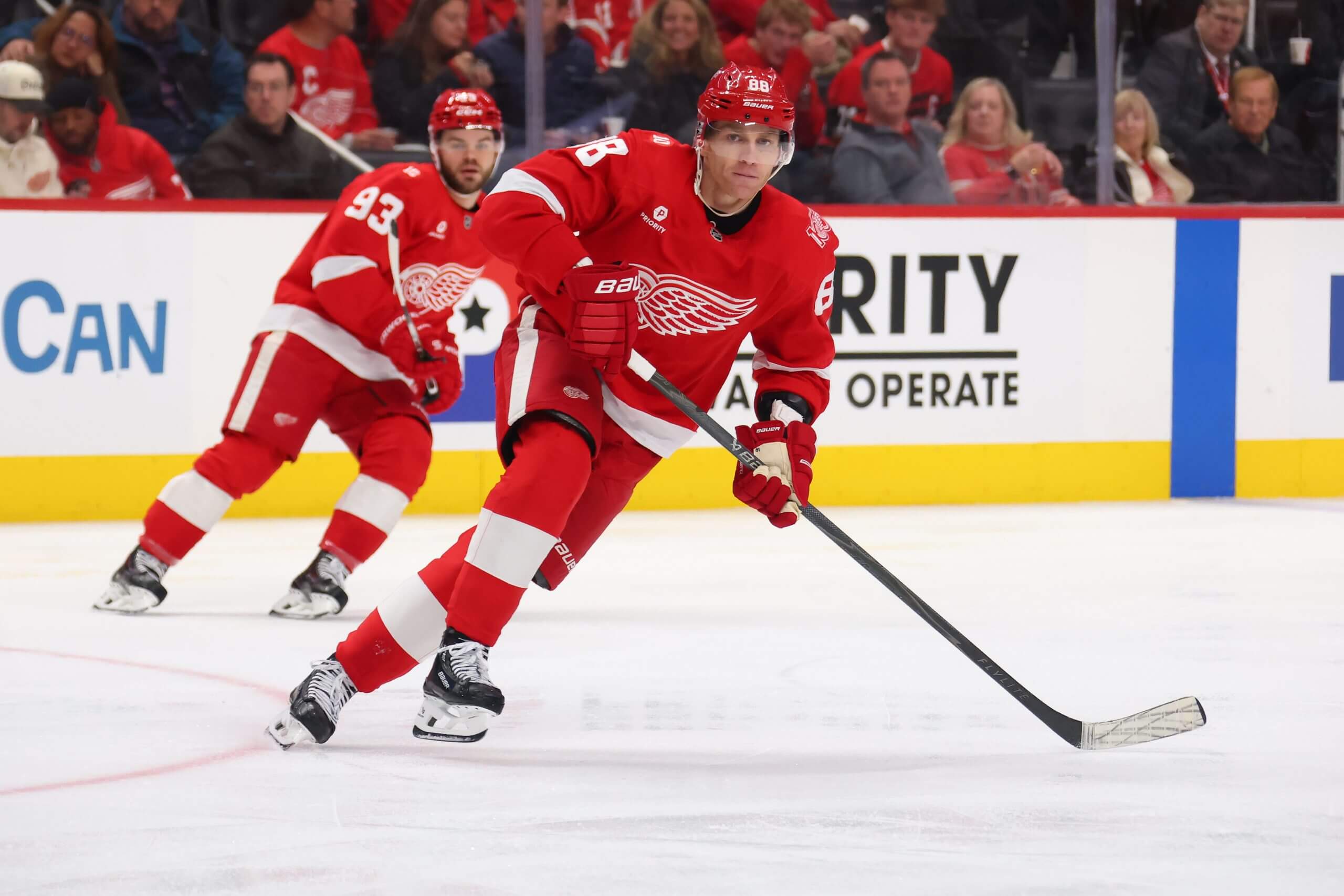 Patrick Kane and Alex DeBrincat skate up the ice.