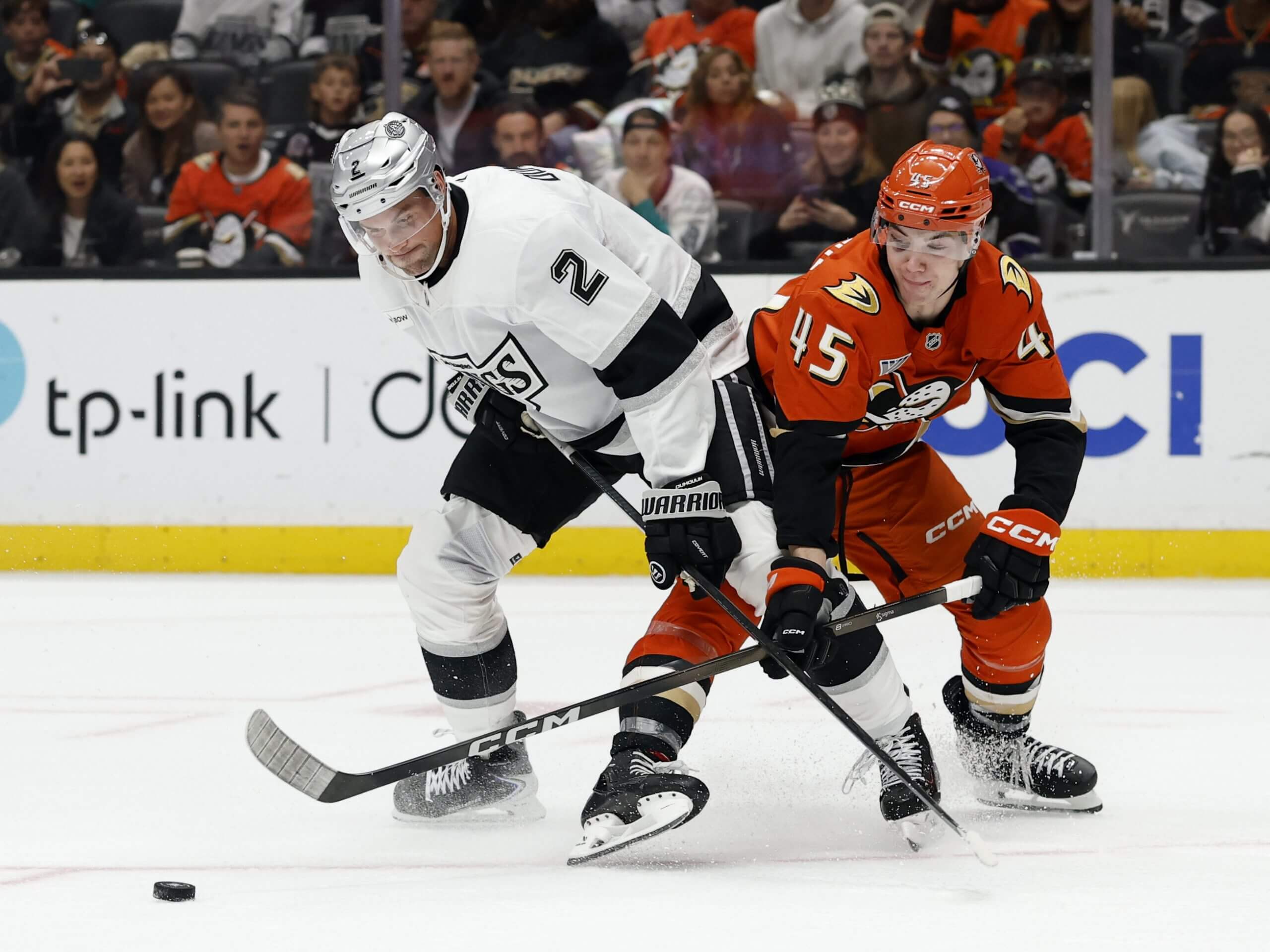 Beckett Sennecke jostles with Los Angeles' Brian Dumoulin for the puck.