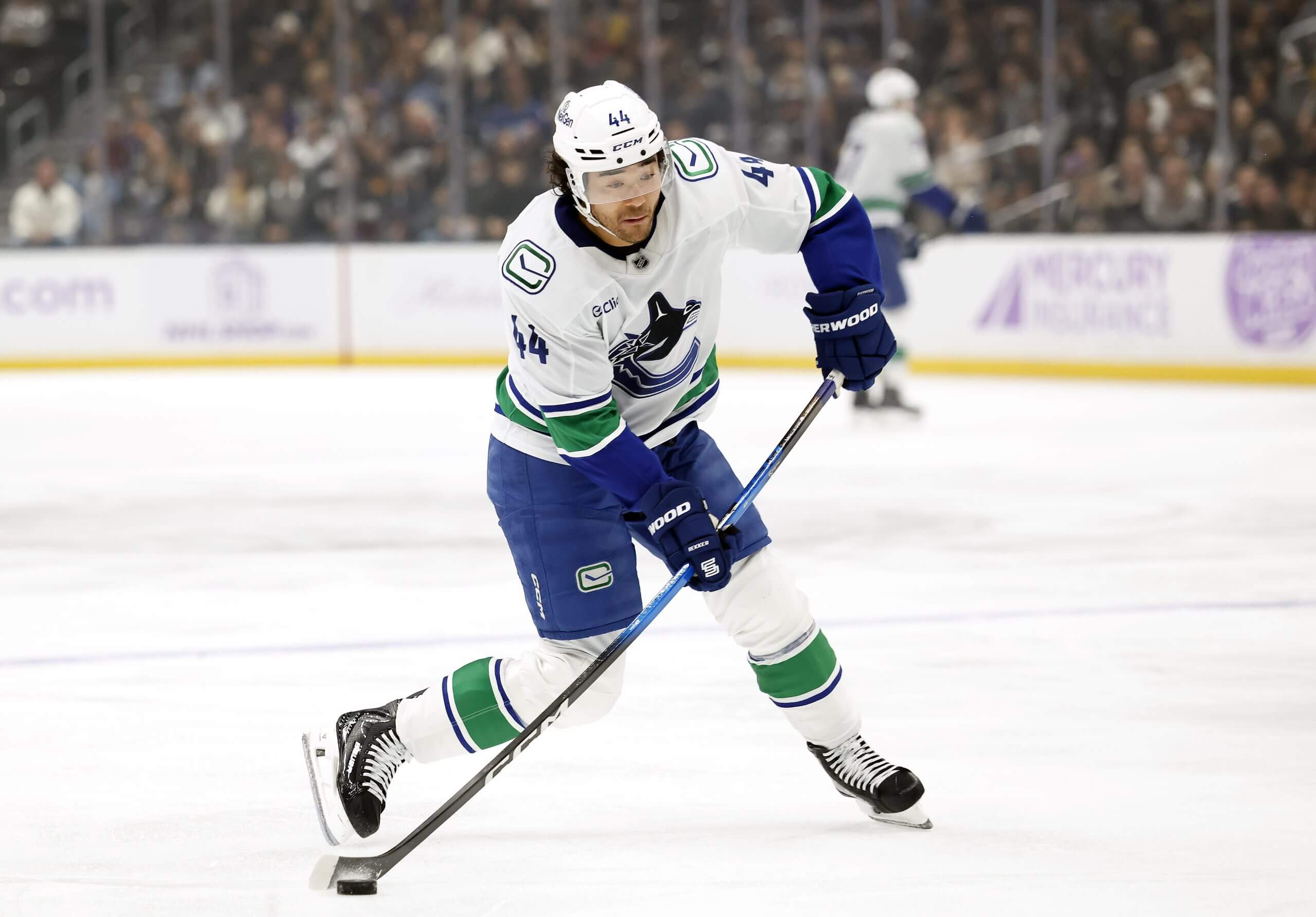 Kiefer Sherwood shoots the puck for the Canucks.