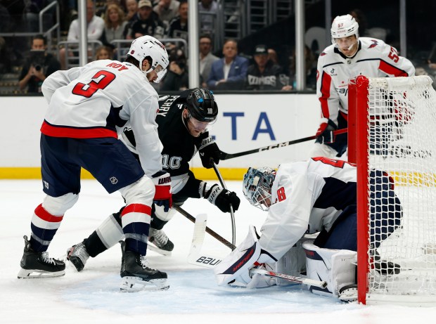 Washington Capitals goaltender Logan Thompson, right, makes a save in...