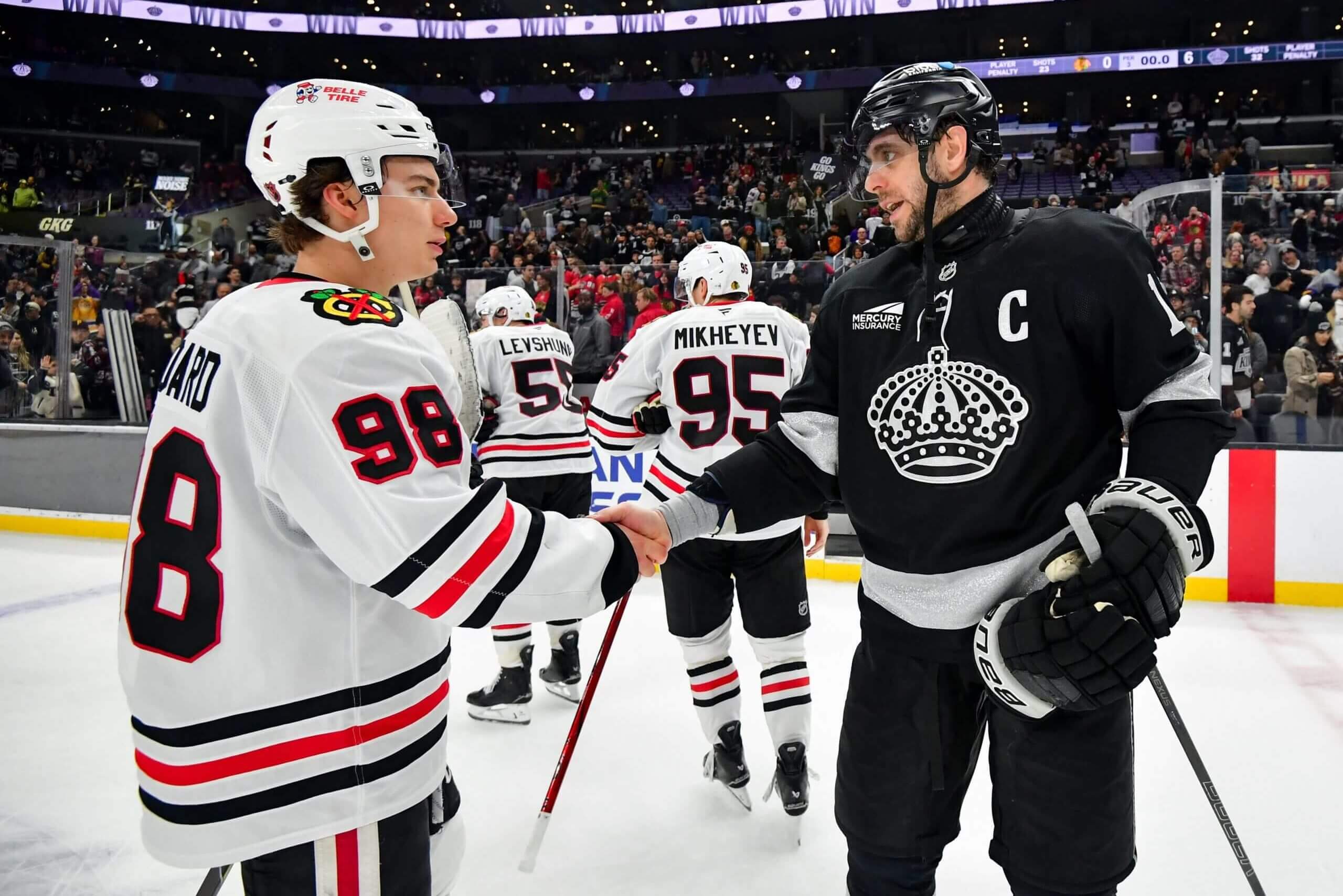 Connor Bedard shakes hands with Anze Kopitar.