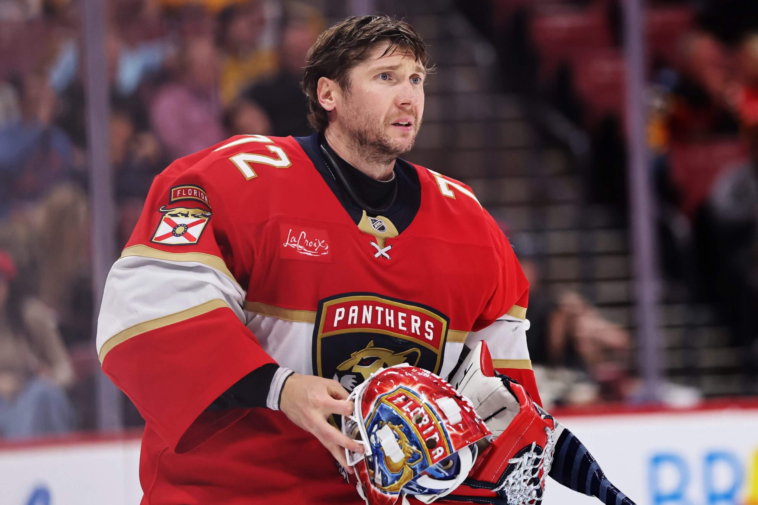 Florida Panthers goalie Sergei Bobrovsky holds his helmet with a furrowed brow.