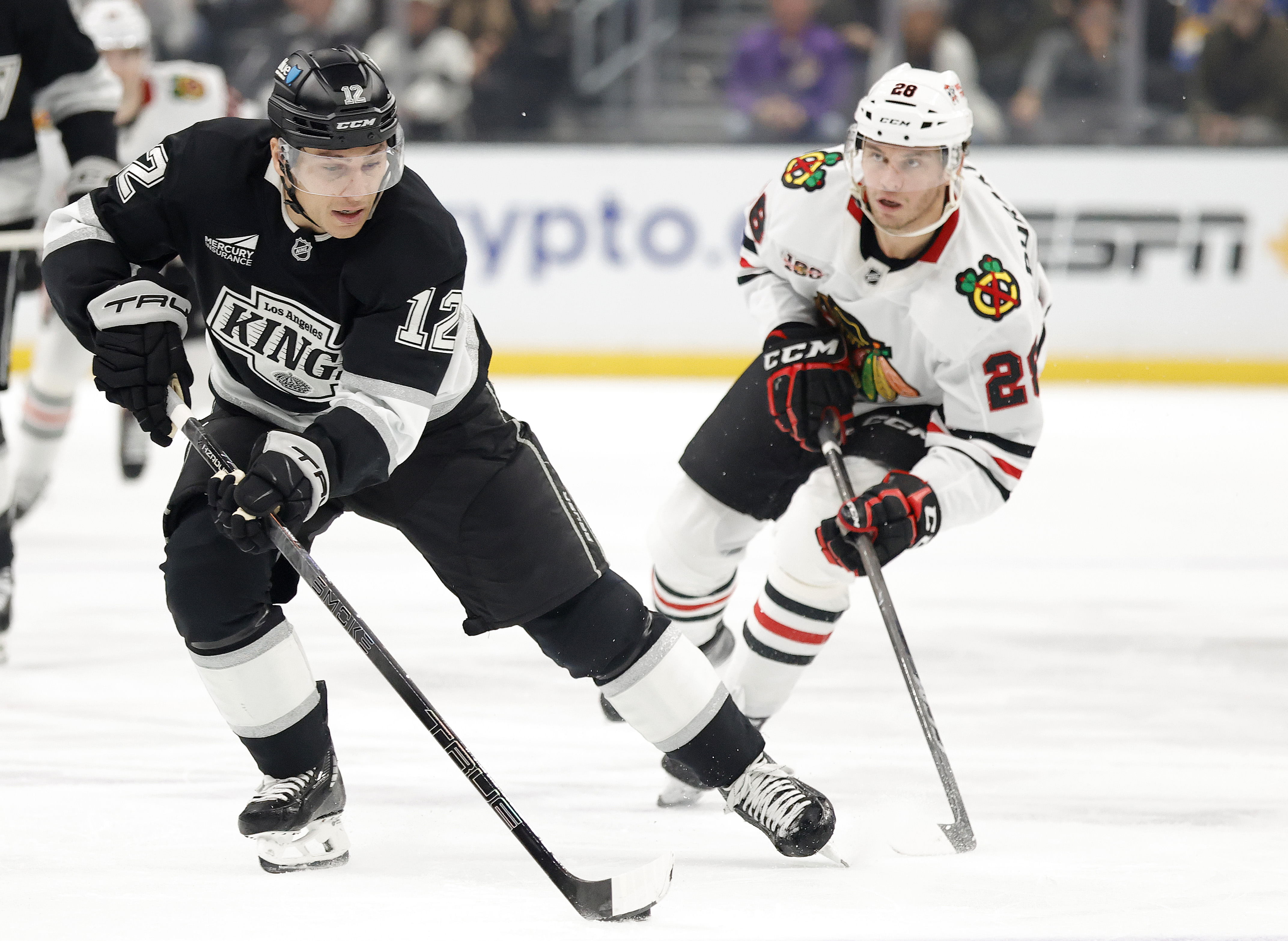 The Kings’ Trevor Moore skates the puck during the second...