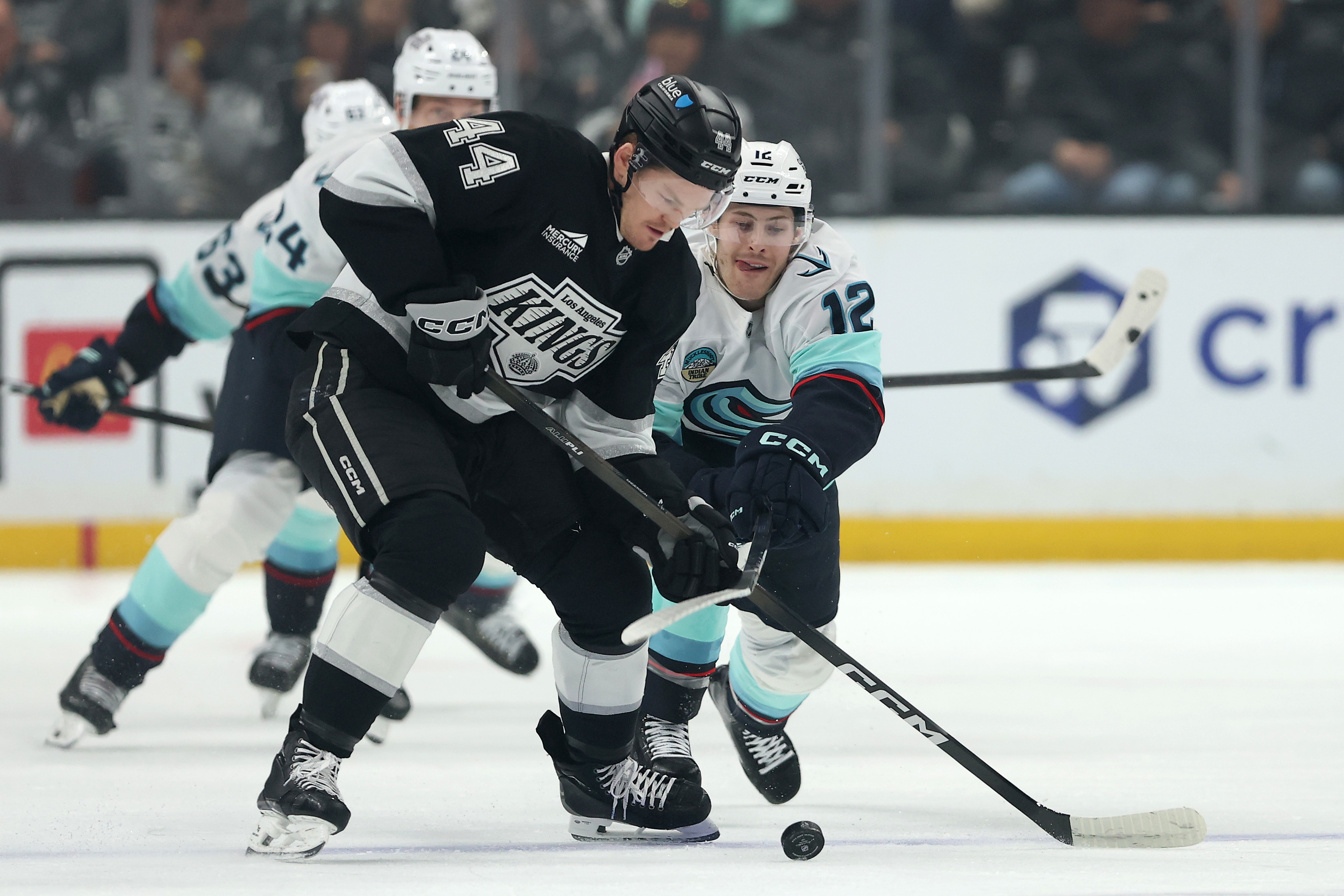 The Seattle Kraken’s Tye Kartye, right, challenges the Kings’ Mikey...