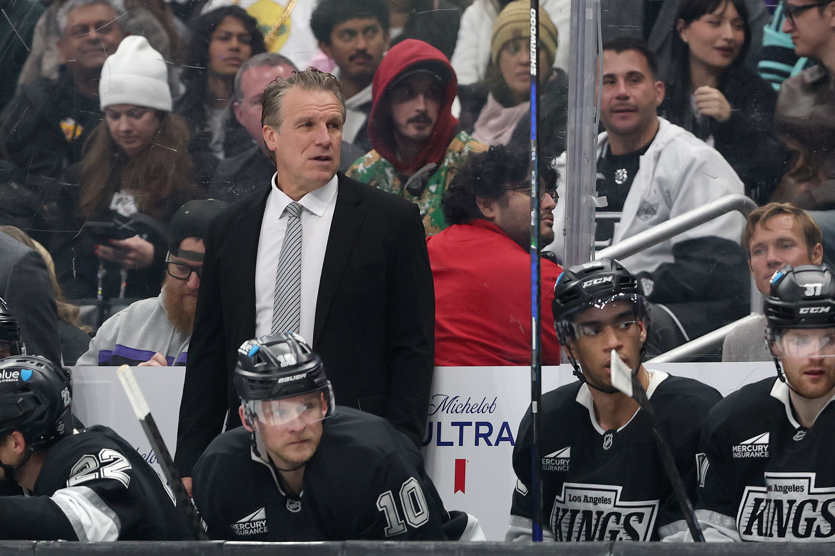 Kings head coach Jim Hiller looks on from the bench...