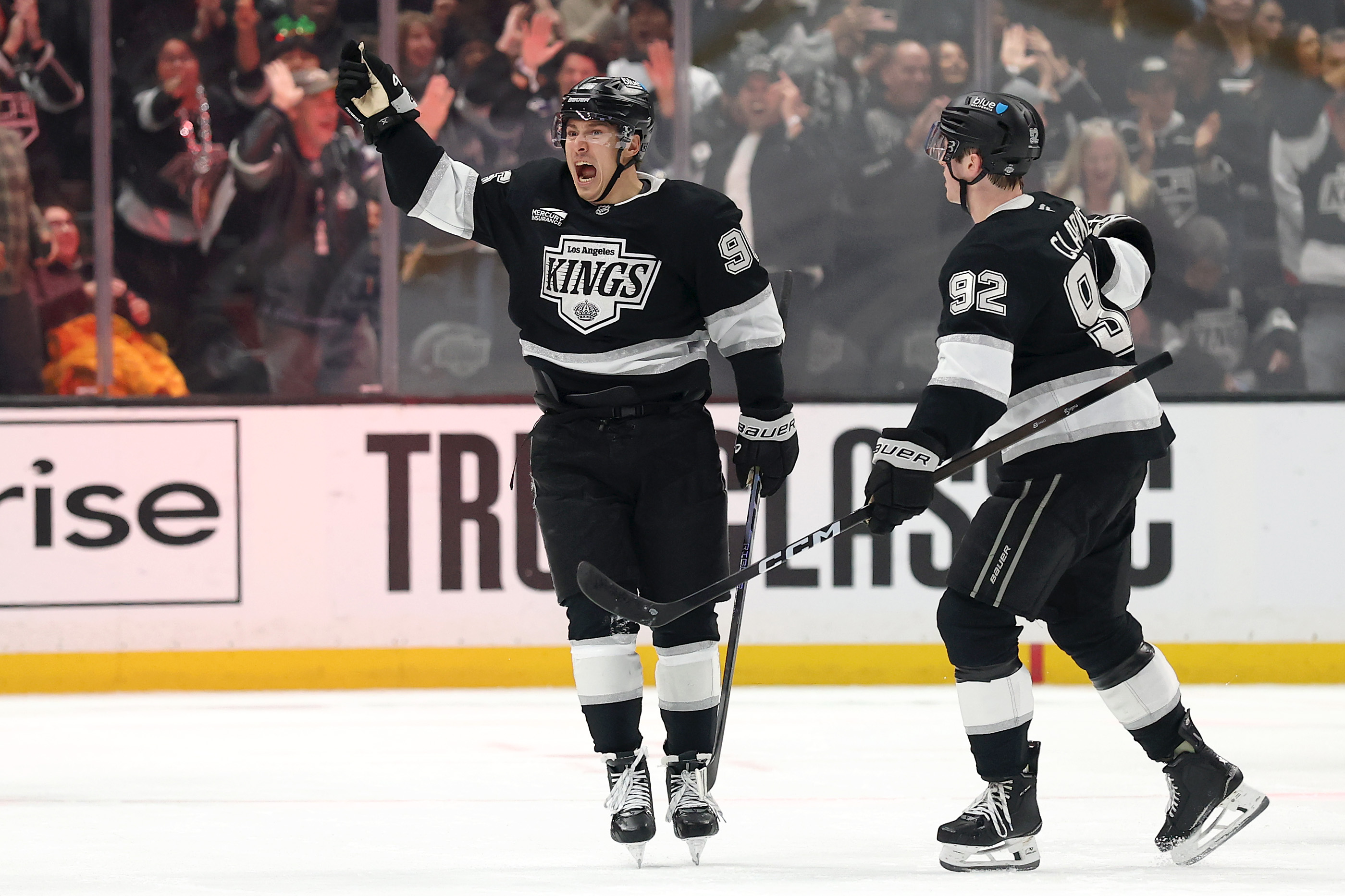 The Kings’ Andrei Kuzmenko, left, celebrates a goal with Brandt...