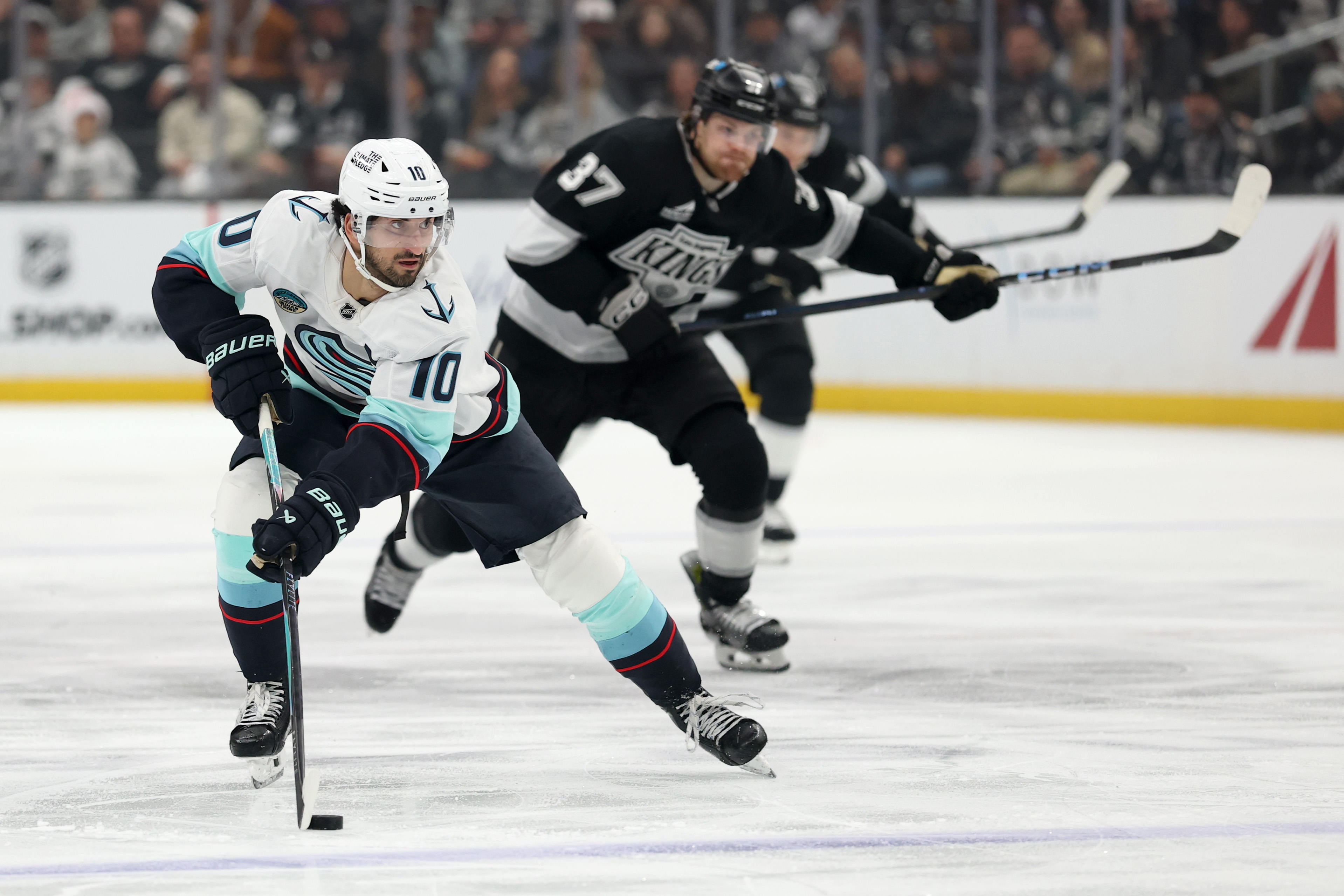 The Seattle Kraken’s Matty Beniers skates with the puck during...